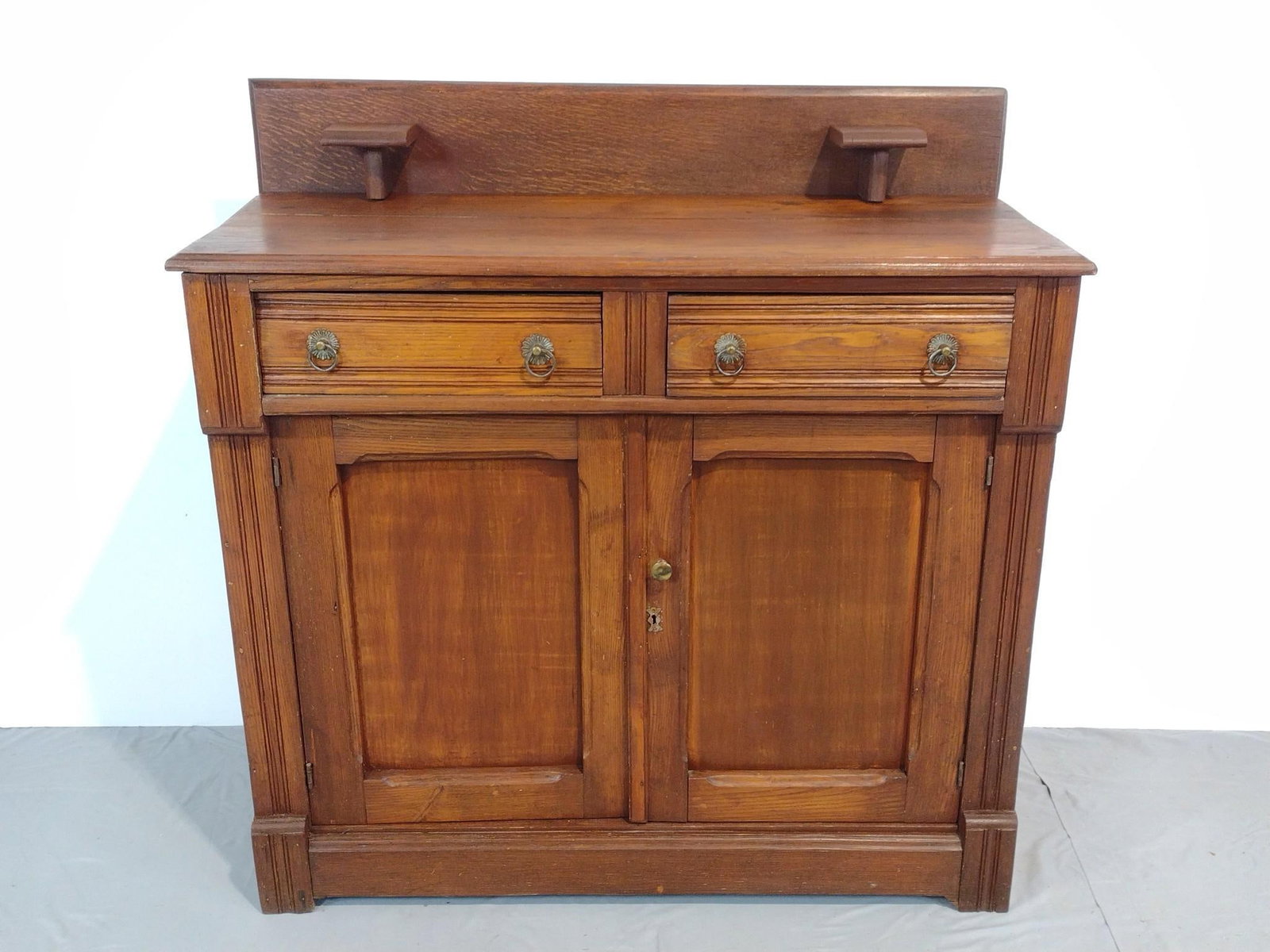 Oak Sideboard: NOT ELIGIBLE FOR IN-HOUSE SHIPPING. 42" wide X 17" deep X 43" high. Has some scratches and areas of finish loss. PROVENANCE: This lot was consigned by the former Double Eagle Antiques on North Second 