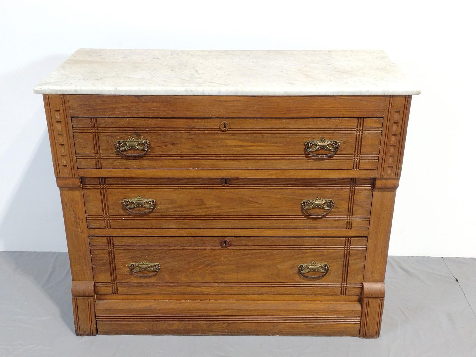 Marble Top Dresser: NOT ELIGIBLE FOR IN-HOUSE SHIPPING. 40" wide X 18-1/2" deep X 33" high. Has some light scratches. Marble Top has some discoloring. PROVENANCE: This lot was consigned by the former Double Eagle Antique