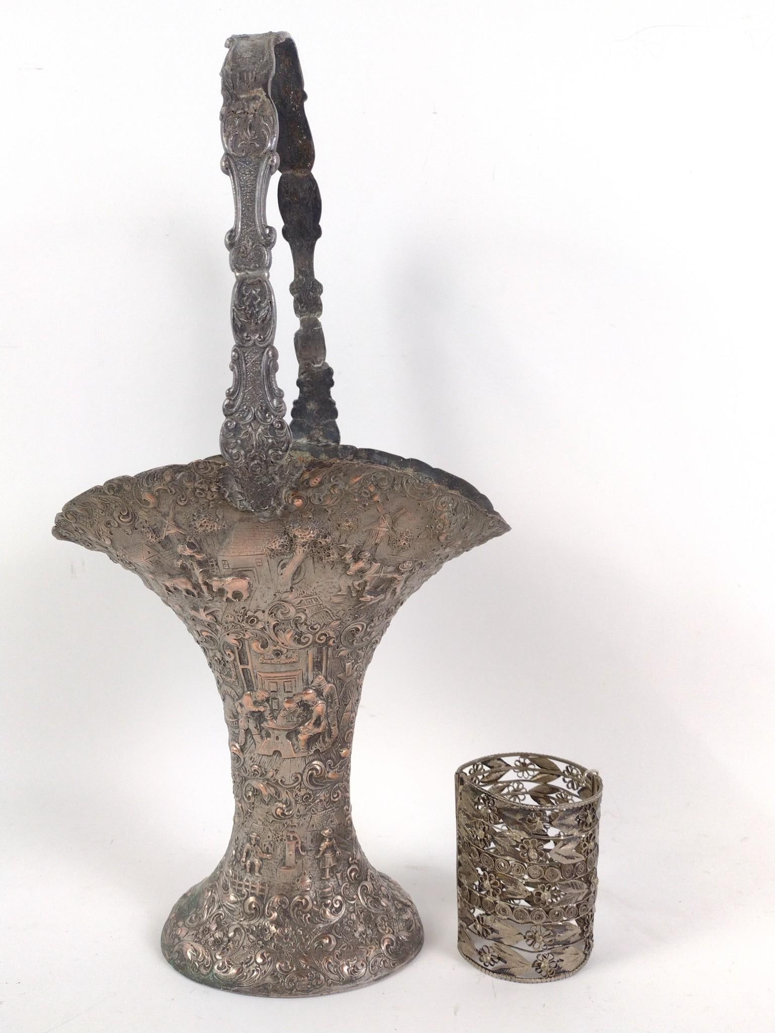 Silver Filigree Cuff and Mixed Metal Basket: Cuff: 2-3/4" diameter x 3-1/3" long. Some discoloration. Also includes mixed metal basket marked "K S 83647" under base. 8-1/4" to 5-1/2" deep x 16-1/2" high. Some discoloration. PROVENANCE: This lot 