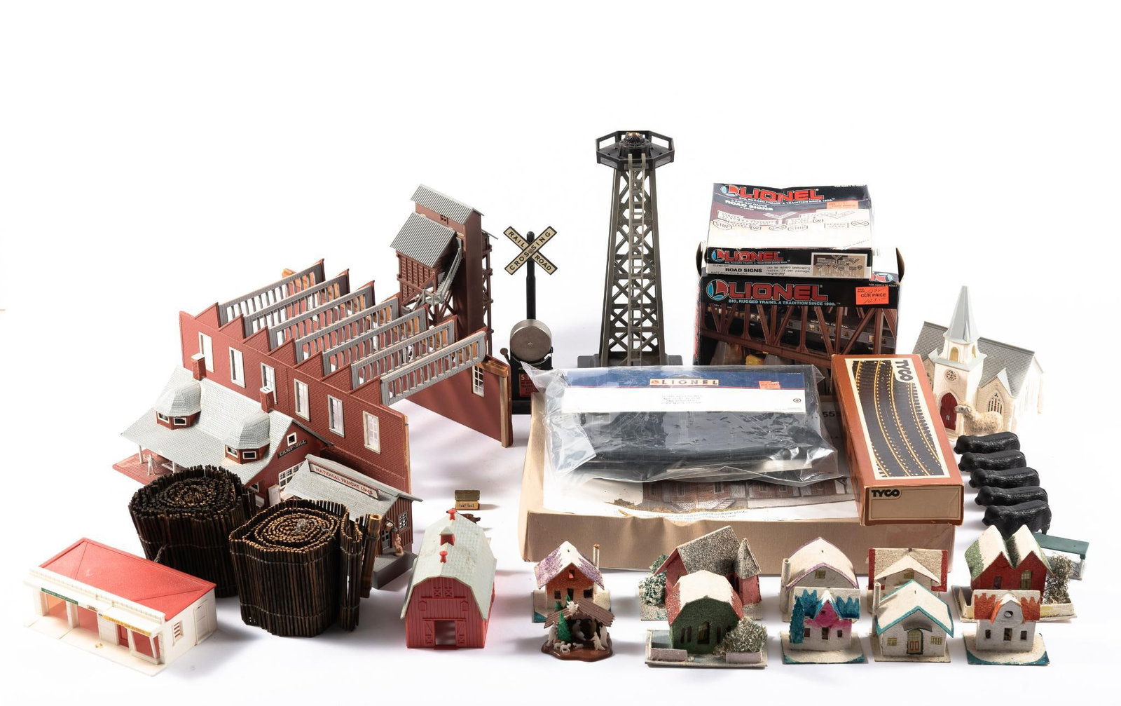Lionel O-Gauge and HO-Gauge Accessories & Buildings: DESCRIPTION: Includes 1940s Japanese paper houses, plastic Lionel buildings, HO Tyco track, and more. CONDITION: Overall good with normal wear and tear associated with use. MEASUREMENTS: Smallest -- 2
