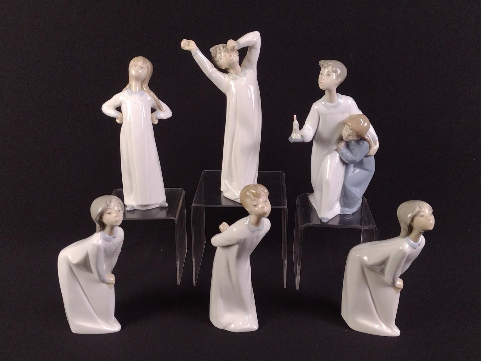 6 Lladro and Nao Child Figurines: Children in pajamas. 7-1/2" to 8-1/2" height. 2-1/4" to 4-1/4" width. Two figurines with repairs.