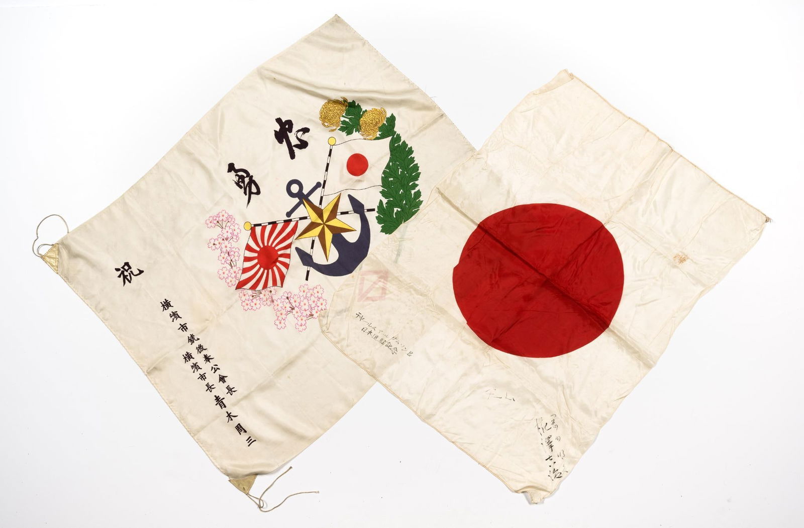 2 WWII Japanese Flags: (1) WWII Military Support Silk Flag. Fine silk flag that carries the declaration of "Loyalty & Bravery" above a display of crossed Japanese flags and the star and anchor emblems of the Japanese Army a
