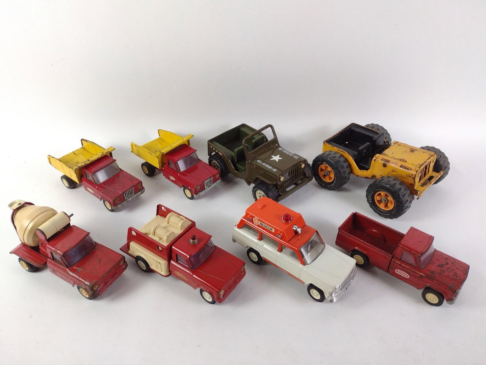 8 Vintage Tonka Trucks incl Rescue: NOT ELIGIBLE FOR IN-HOUSE SHIPPING. 9" to 10" long. All with varies degrees of paint loss, rust, and general wear.