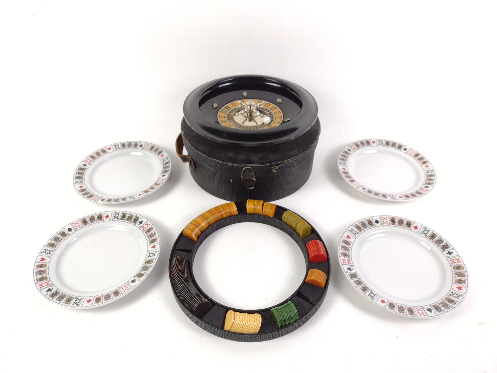 4 Poker Plates & Roulette Wheel: Roulette wheel inside carrying case. 7-1/2" to 10-1/4" wide.