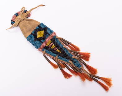Early 20th Century Sioux Beaded Pouch: DESCRIPTION: An antique pouch with beadwork and tin cone tasles with dyed horsehair. MEASUREMENTS: Length 11". CONDITION: Fading and soiling due to age but no damage noted.