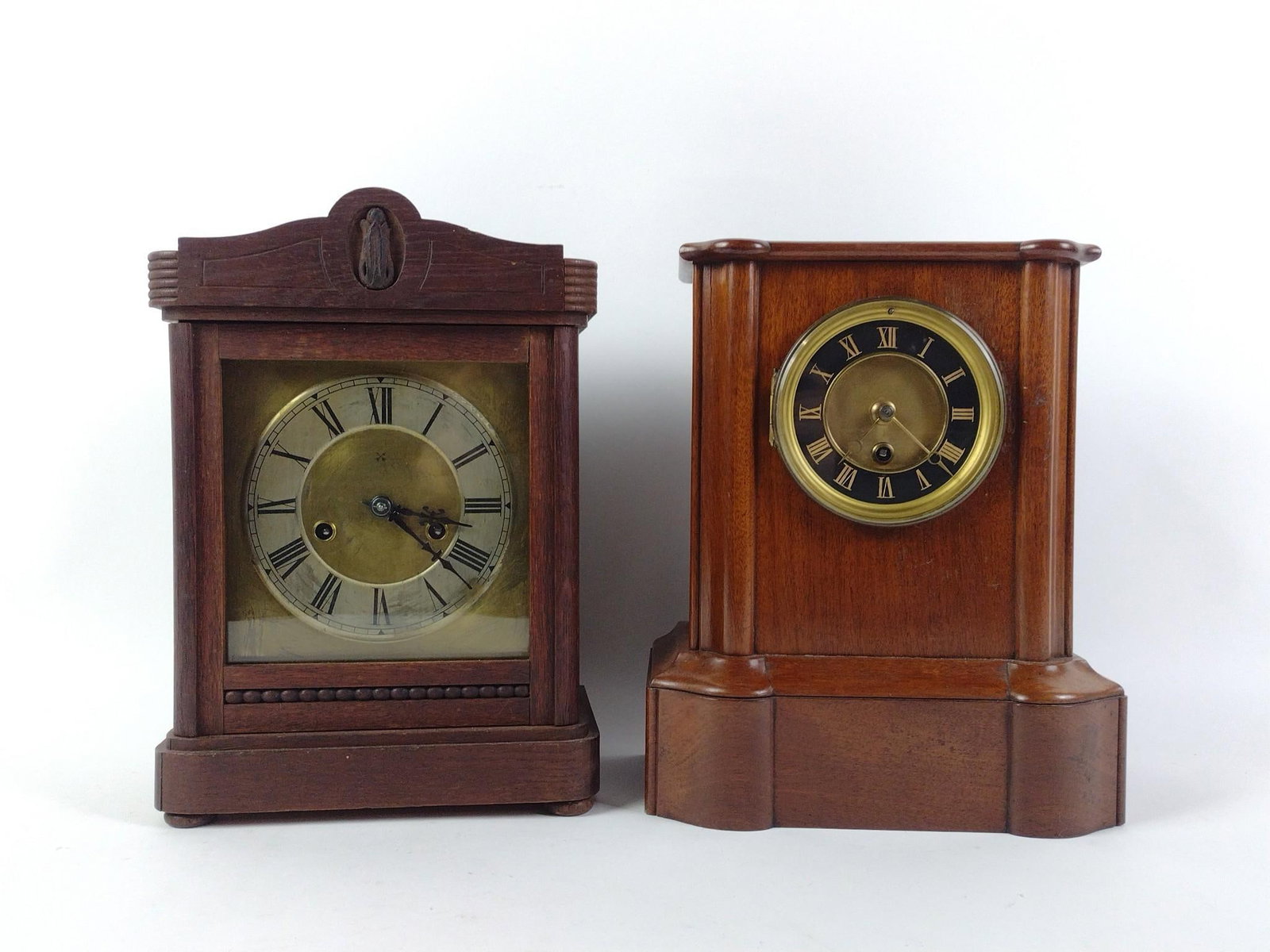 2 Vintage Mantle Clocks: NOT ELIGIBLE FOR IN-HOUSE SHIPPING. Darker wood starts and stops. Has key. Lighter wood is untested. Does not have pendulum or key. Each approximately: 9-1/2" wide x 6" deep x 11-3/4" high. Both with 