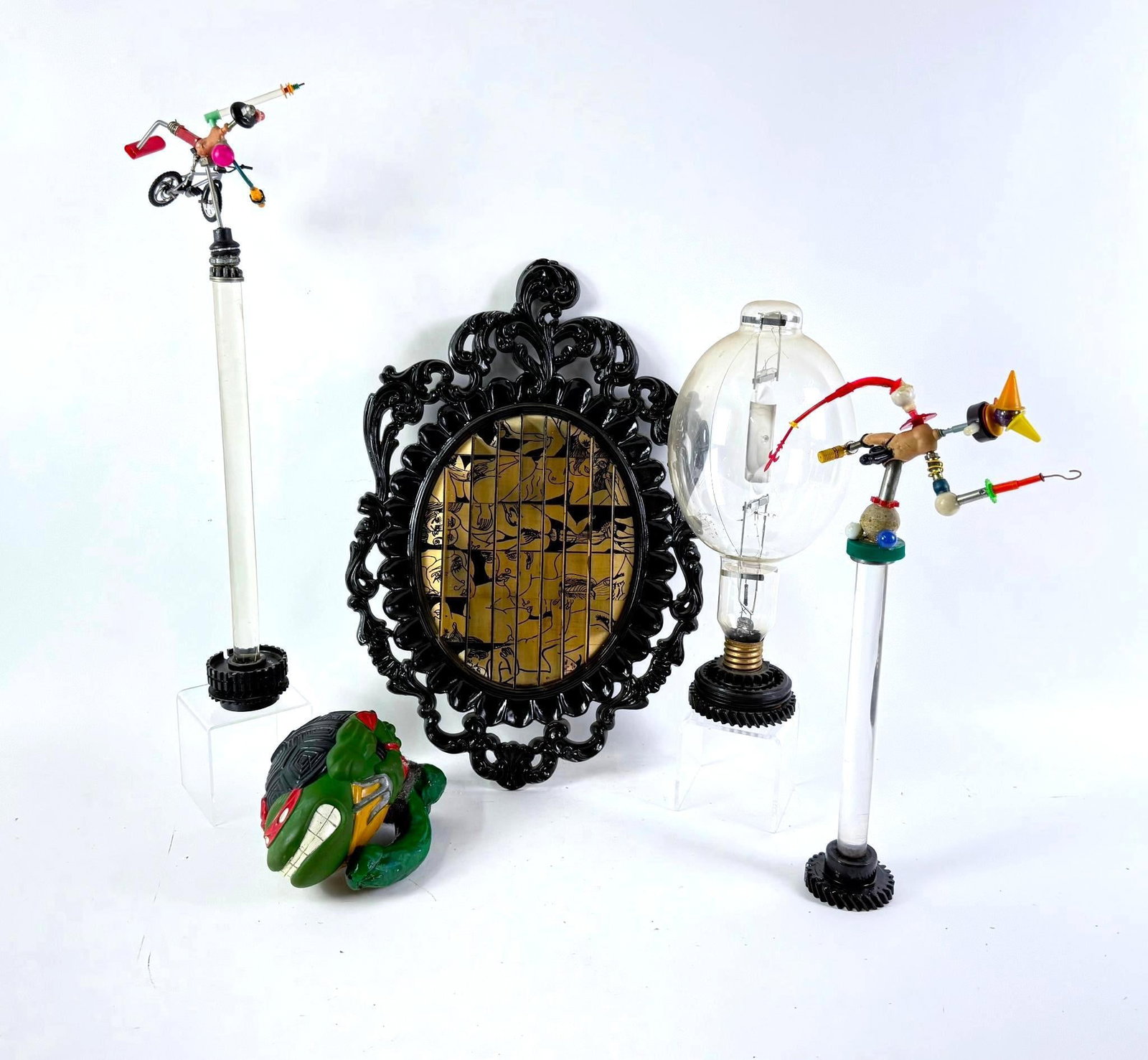 4 Yigal Elyadin Pop Culture Found Obect Sculptures And 1 Wood Transfer Erotica: NOT ELIGIBLE FOR IN-HOUSE SHIPPING. Includes Teenage Mutant Ninja Turtles, BMX, and more. Measures 3-1/2" to 9" wide x 6" to 23" high. PROVENANCE: From the Estate of Yigal Elyadin. Yigal Elyadin was b