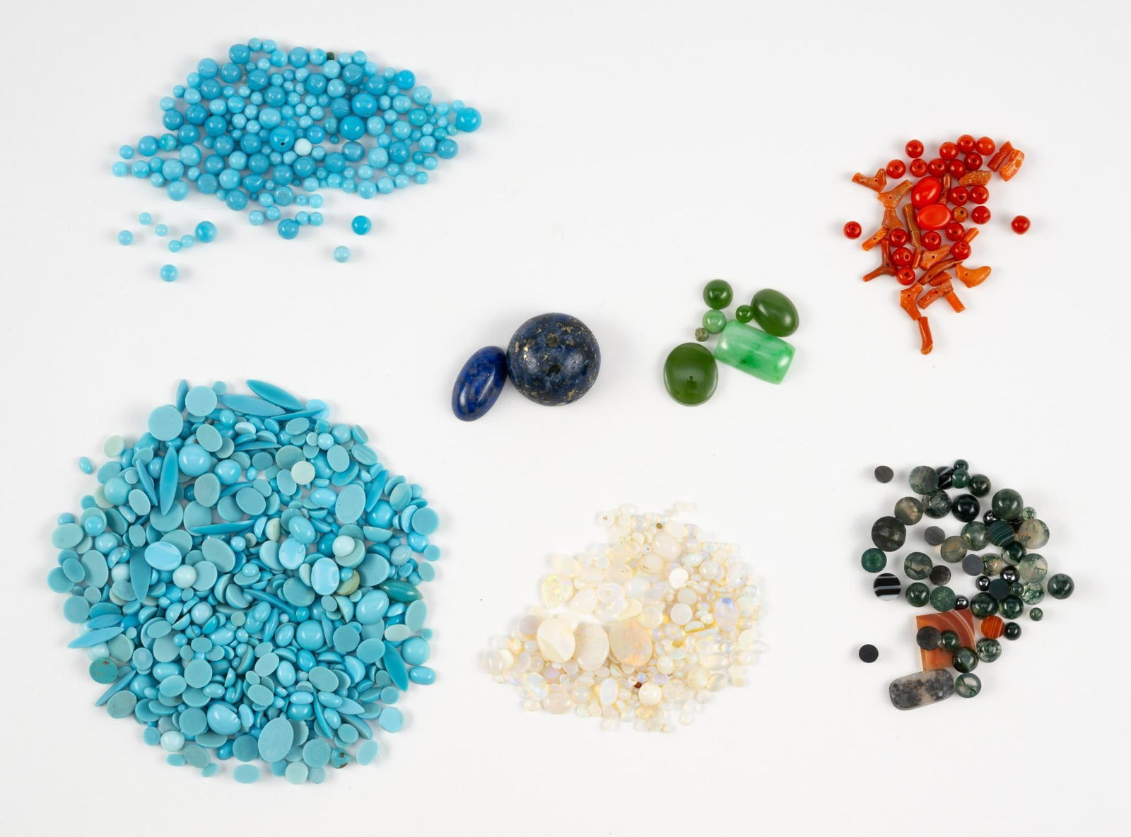 Collection of Loose Gemstones: Includes turquoise, opal, coral, jade, agate, and lapis lazuli.