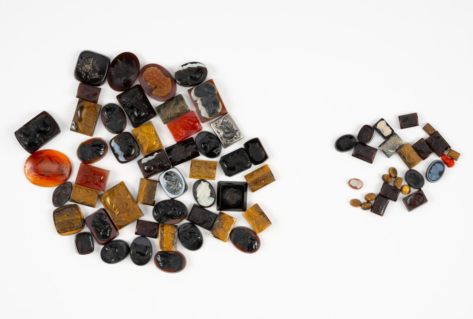 Collection of Loose Intaglios & Cameos: Includes onyx, sardonyx, tigers eye, sard, carnelian, hematite, and coral, and glass. Largest 1" height.