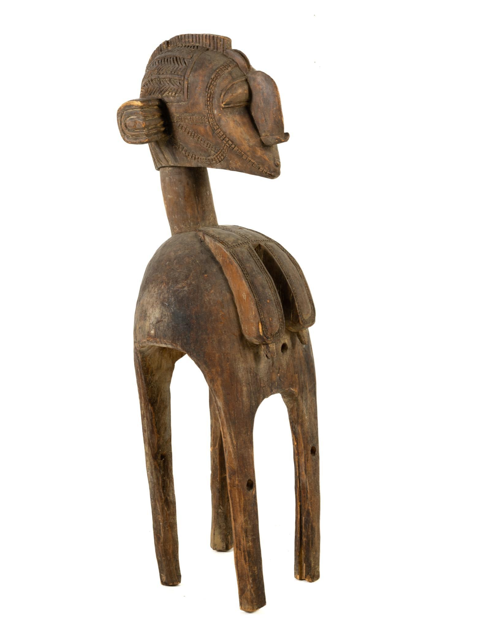 Baga Nimba Carved Fertility Statue: NOT ELIGIBLE FOR IN-HOUSE SHIPPING. Baga are a West African ethnic group who live in the southern swampy lands of Guinea Atlantic coastline. Measure 17" wide x 18" deep x 55" high. Loss of finish.