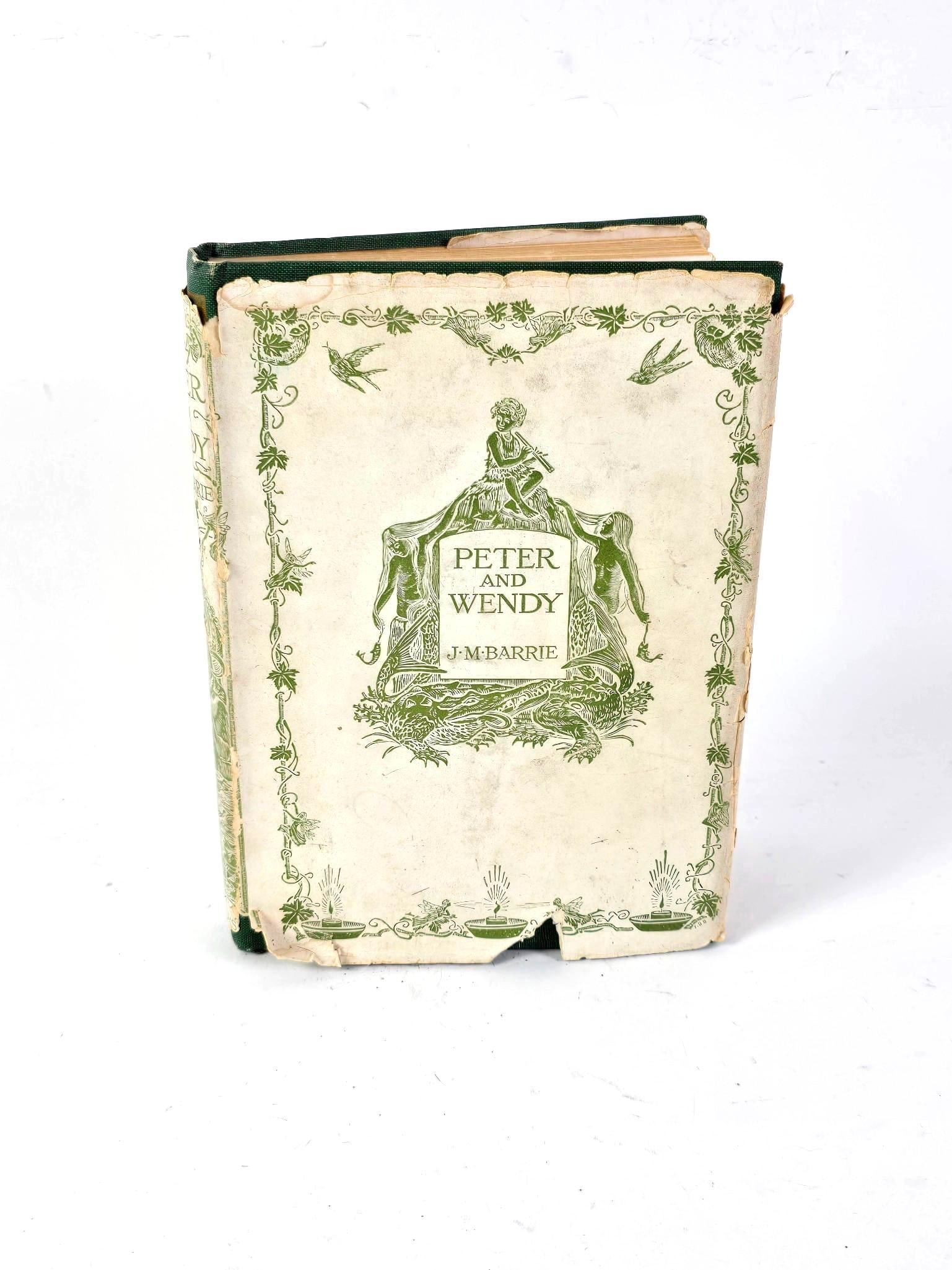 1911 J. M. Barrie Peter and Wendy: Includes 9 bookplate images and pictorial title page. Copyright 1911 by Charles Scriner's Sons. Losses and discoloration to jacket. Losses, separation, minor markings and some discoloration to book.
