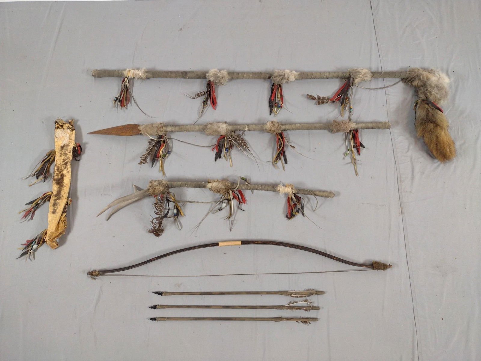 4 Native American Ceremonial Pieces, Bow and 3 Arrows: NOT ELIGIBLE FOR IN-HOUSE SHIPPING. Ceremonial items embellished with feathers and beads. 21" to 62" long.