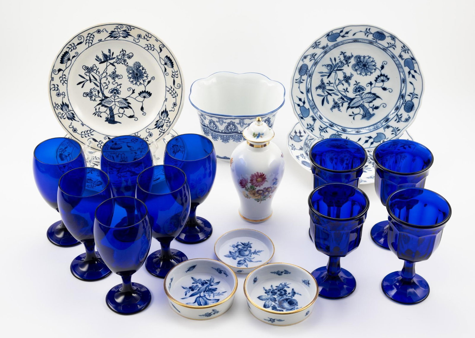 19 Pcs of Ceramics: Includes stemware, jar, and more. Measures 4" to 7" wide x 3/4" to 5" high. Small chip to rim of one plate.