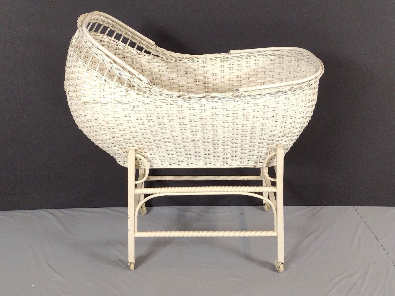 Wicker Bassinet: NOT ELIGIBLE FOR IN-HOUSE SHIPPING. 18" wide X 34" deep X 38-1/2" high. Has some areas of paint loss.