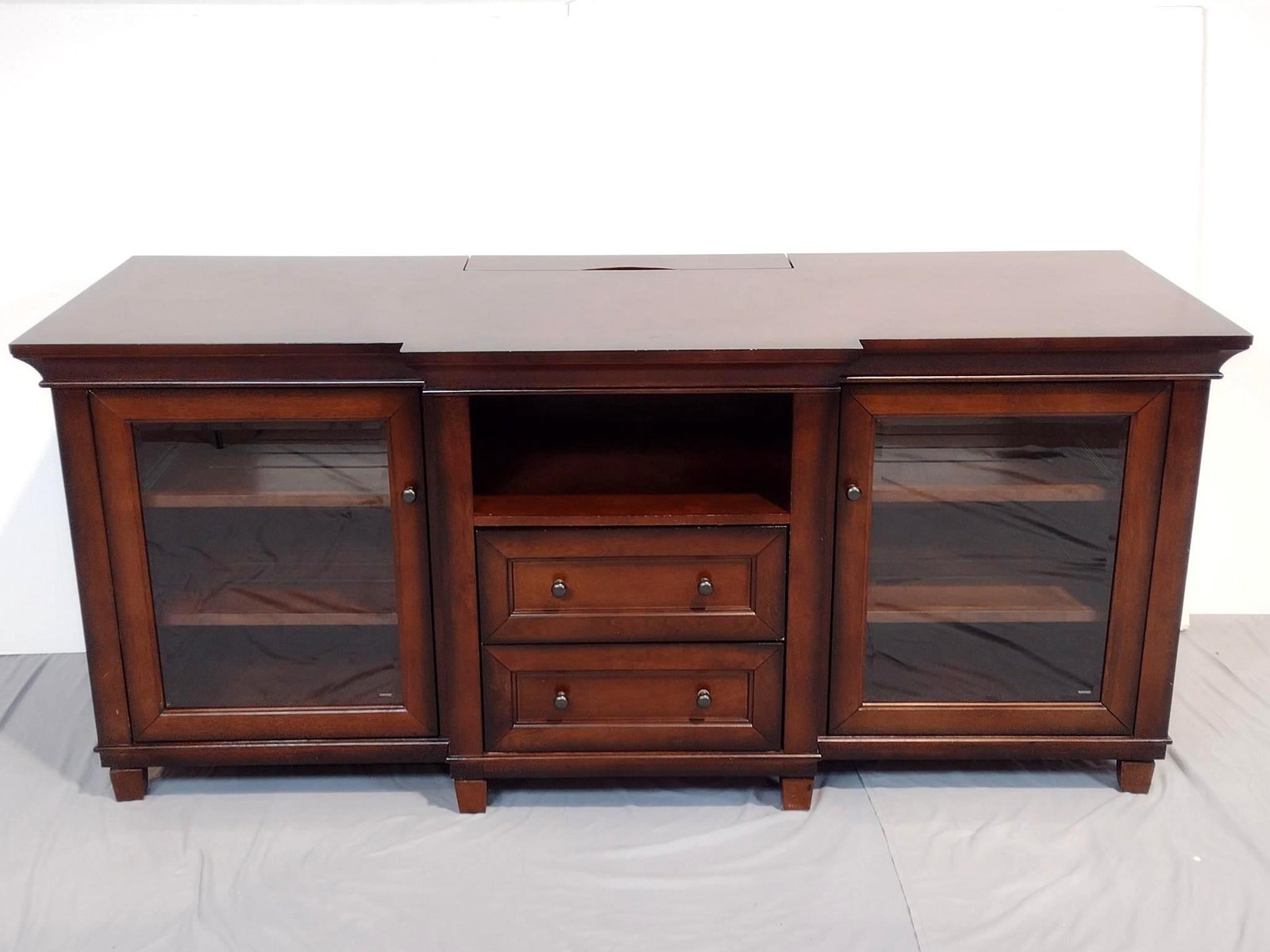 Martin Furniture Glass Front Entertainment Stand: NOT ELIGIBLE FOR IN-HOUSE SHIPPING. Slider side cabinet shelves. 70-1/2" wide X 26" deep X 31" high. Some scratches and minor finish losses.