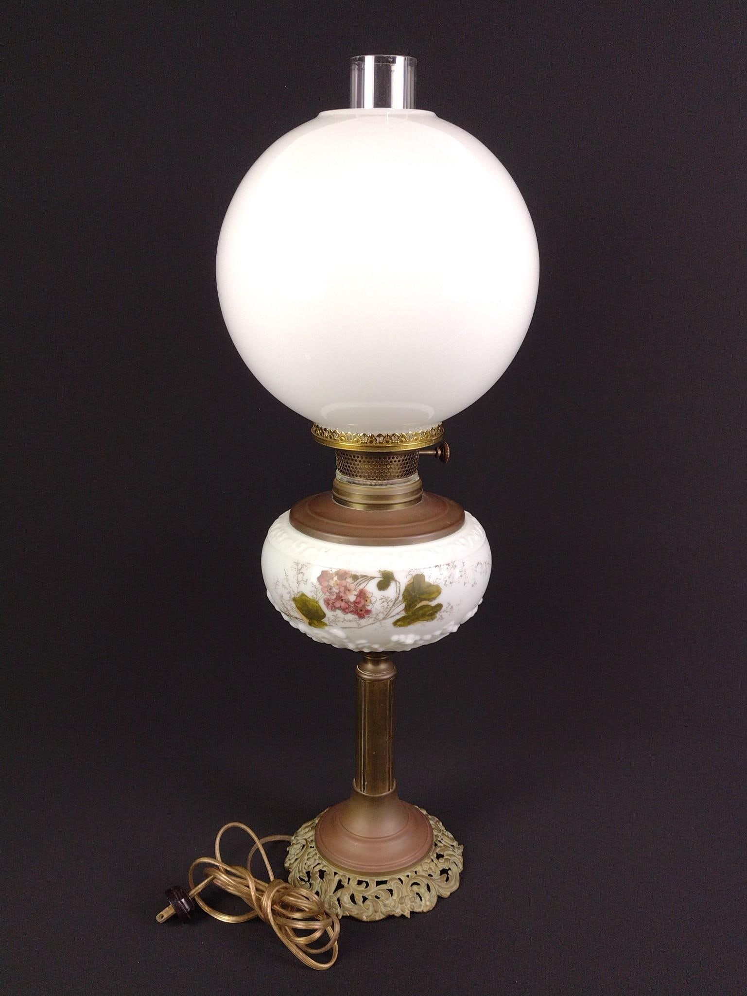Electrified Gone with the Wind Lamp: NOT ELIGIBLE FOR IN-HOUSE SHIPPING. Overall: 9" diameter x 26-1/2" high. Chip to chimney. Rough bottom edge to shade.