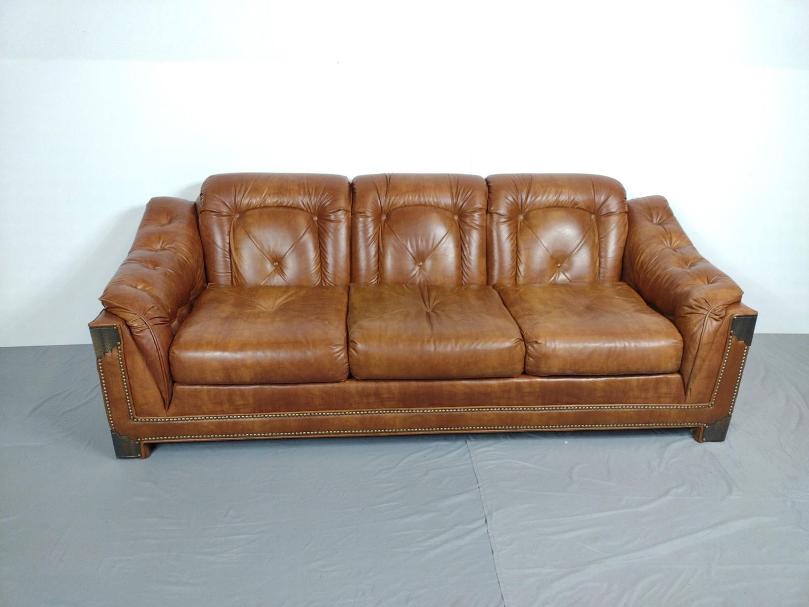 Sears Synthetic Leather Sofa With Brass Accents: NOT ELIGIBLE FOR IN-HOUSE SHIPPING. 84" wide X 35" deep X 31" high.