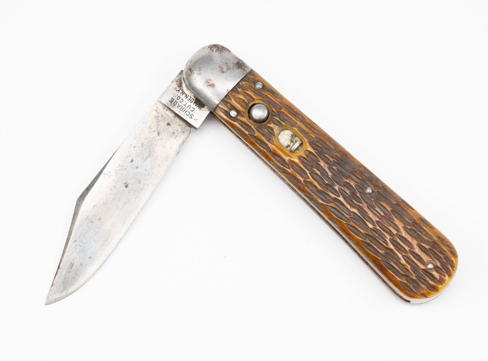 Vintage Schrade Cut Co Switchblade: NOT ELIGIBLE FOR IN-HOUSE SHIPPING OUTSIDE THE UNITED STATES. Brown jigged bone handle. Safety lock. Push button open. Blade marked on front "Schrade Cut Co Walden NY"; marked on back "U.S. Pats Dec 2