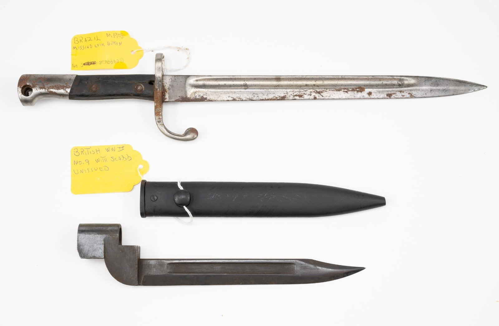 2 Bayonets: NOT ELIGIBLE FOR IN-HOUSE SHIPPING OUTSIDE THE UNITED STATES. Includes Brazilian M1908 marked W.K. & CIE; and British WWII No. 9 marked NO.9 MKI POF60. Brazilian M1908 with no scabbard and no lock but