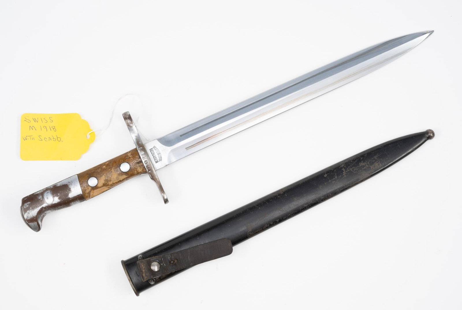 Swiss M1918: NOT ELIGIBLE FOR IN-HOUSE SHIPPING OUTSIDE THE UNITED STATES. With scabbard. Hilt marked 162006. Blade marked Waffenfabrik Neuhausen. 17-3/4" long.