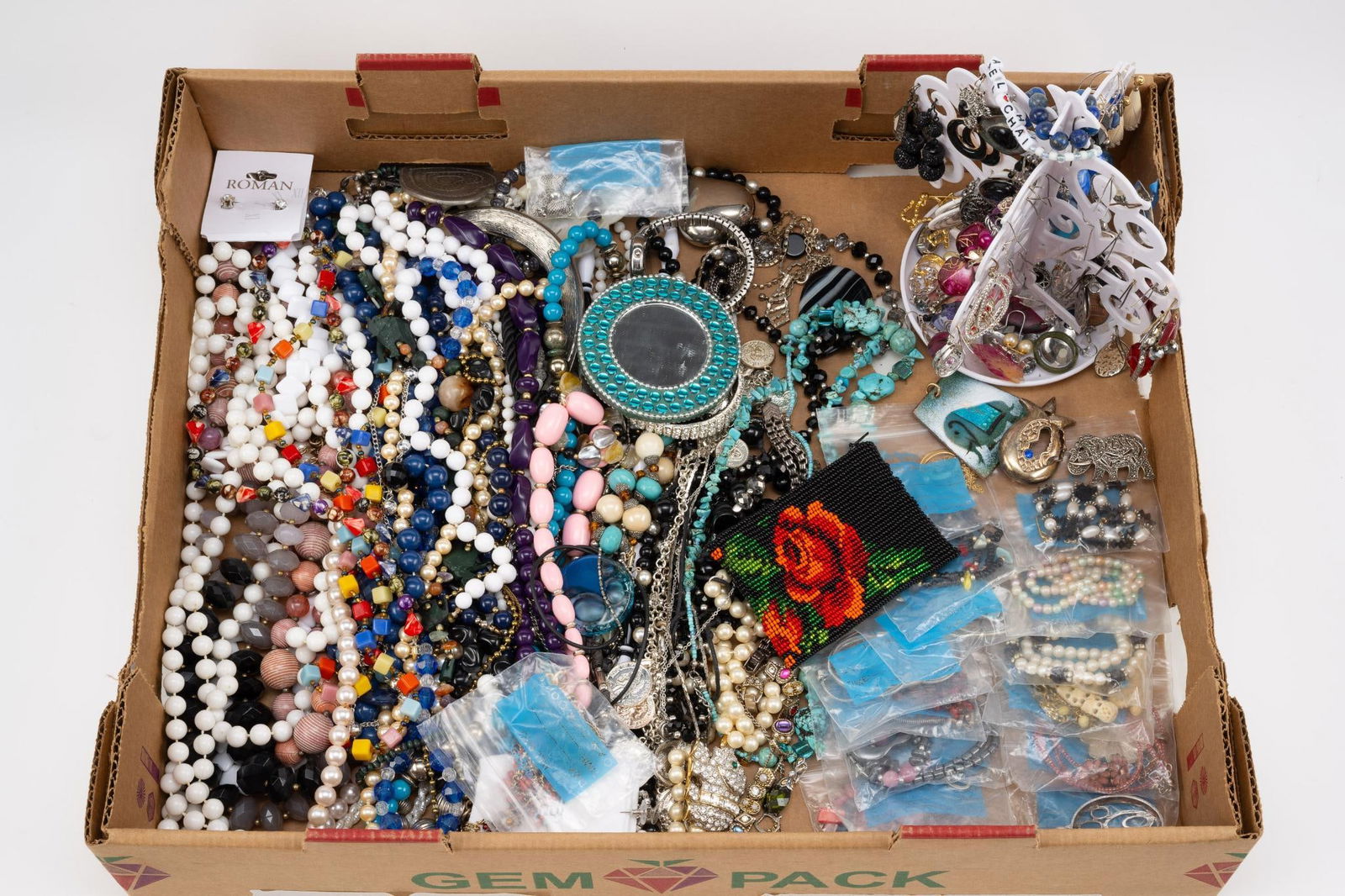 Lot of Costume Jewelry: Includes necklaces, beaded bag, and earrings.