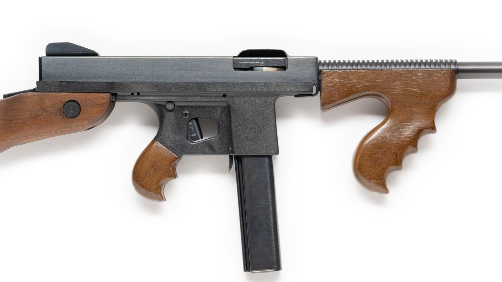 Volunteer Enterprises Commando Mark 45 Semi Auto Carbine, Caliber .45ACP: Serial Number: 65245 Design: The Commando Mark 45 is a striker-fired, semi automatic Thompson Submachine Gun look-alike with a 16" barrel and a Cutts style appendage at the muzzle. Manufactured by Vol