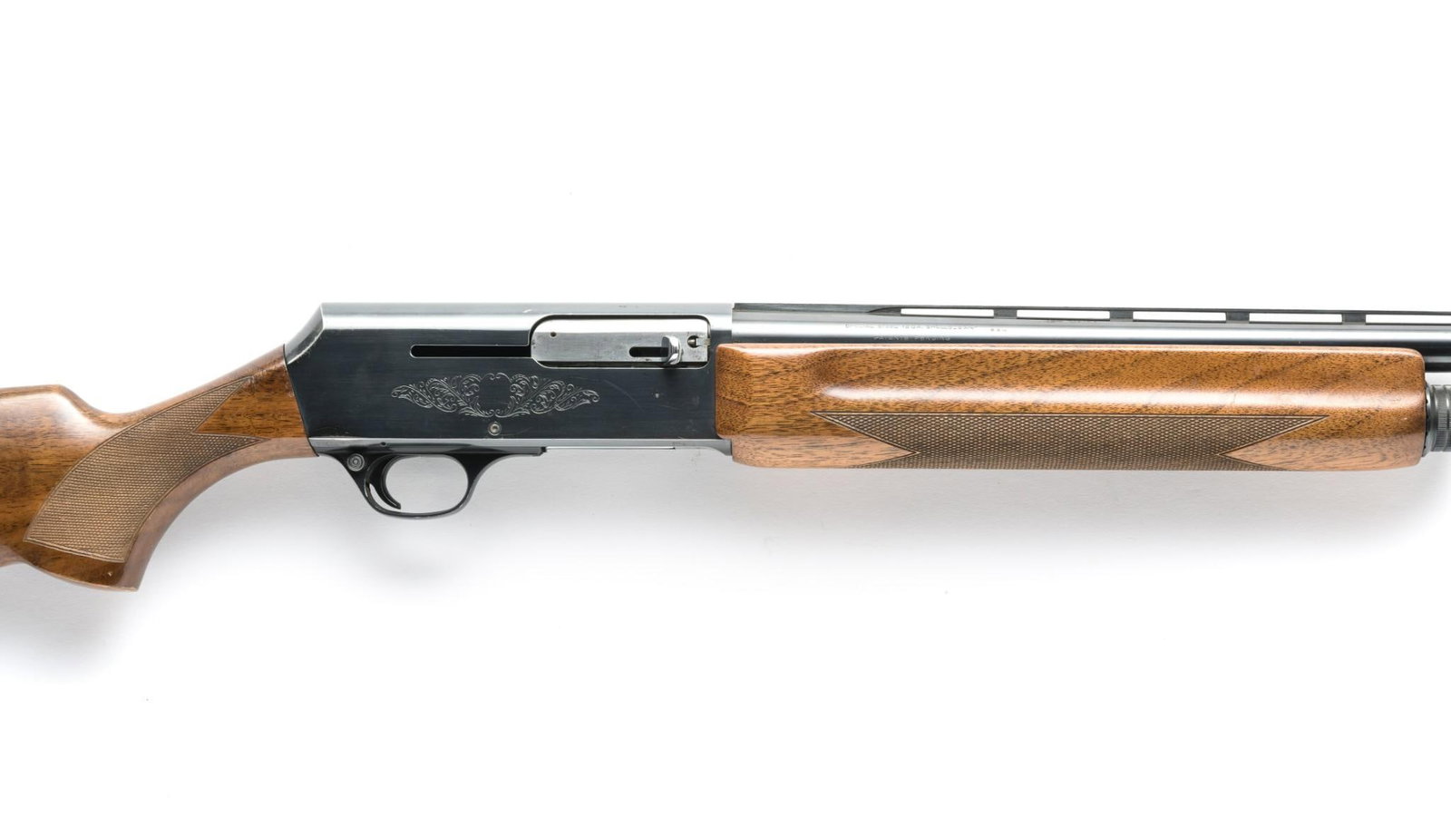 Browning Model 2000 Semi Auto Shotgun, 12 Gauge: Serial Number: V6112 Design: This Browning Model 2000 semi automatic shotgun is set up for 2 3/4" 12 gauge shells. It has a 26" vent rib barrel choked improved cylinder. Gloss finished hardwood stock