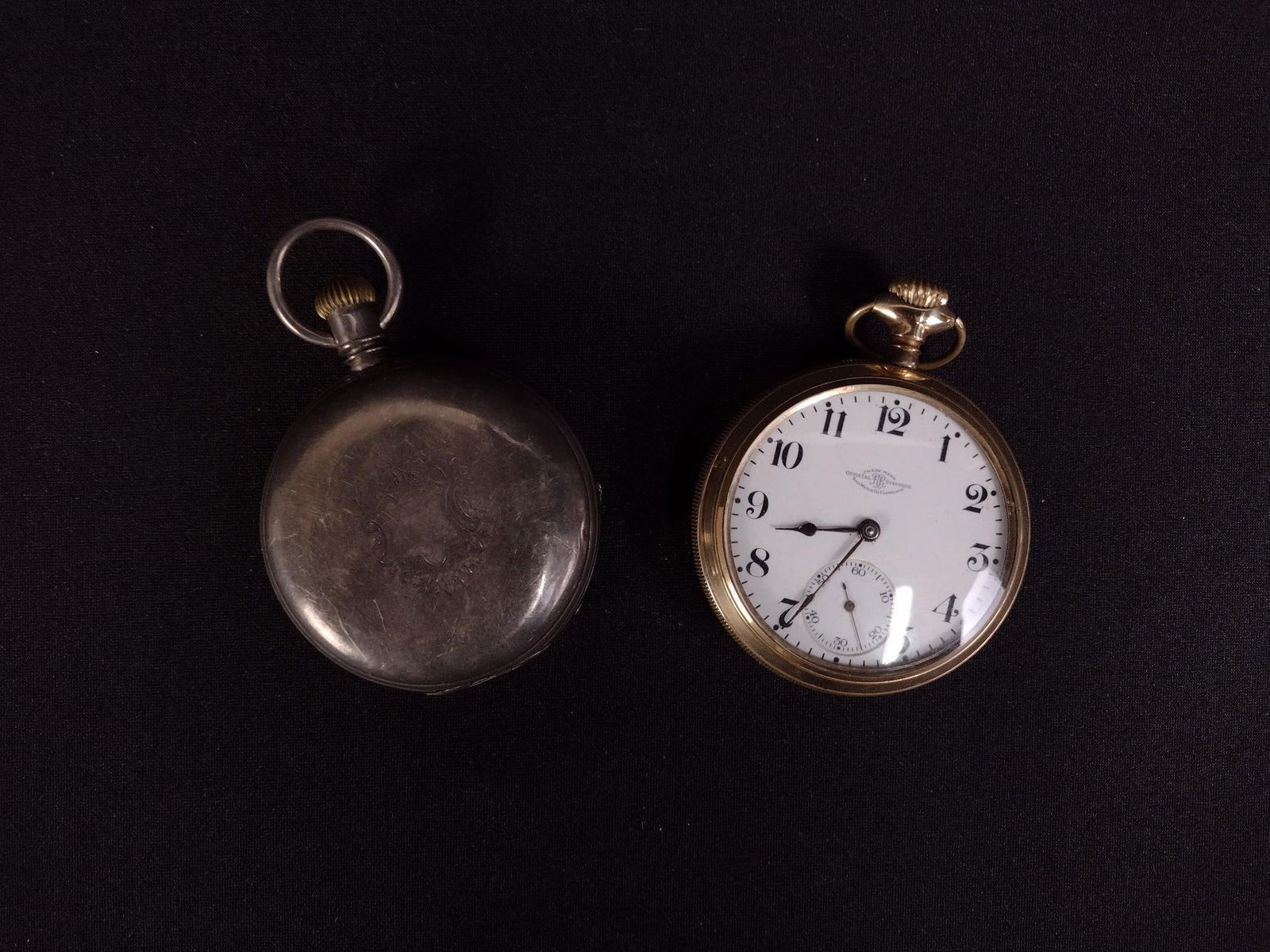 2 Pocket Watches incl Elgin and Ball Watch Co: Elgin silver toned watch not working. Serial number B2699. Ball Watch Co gold toned watch is working.