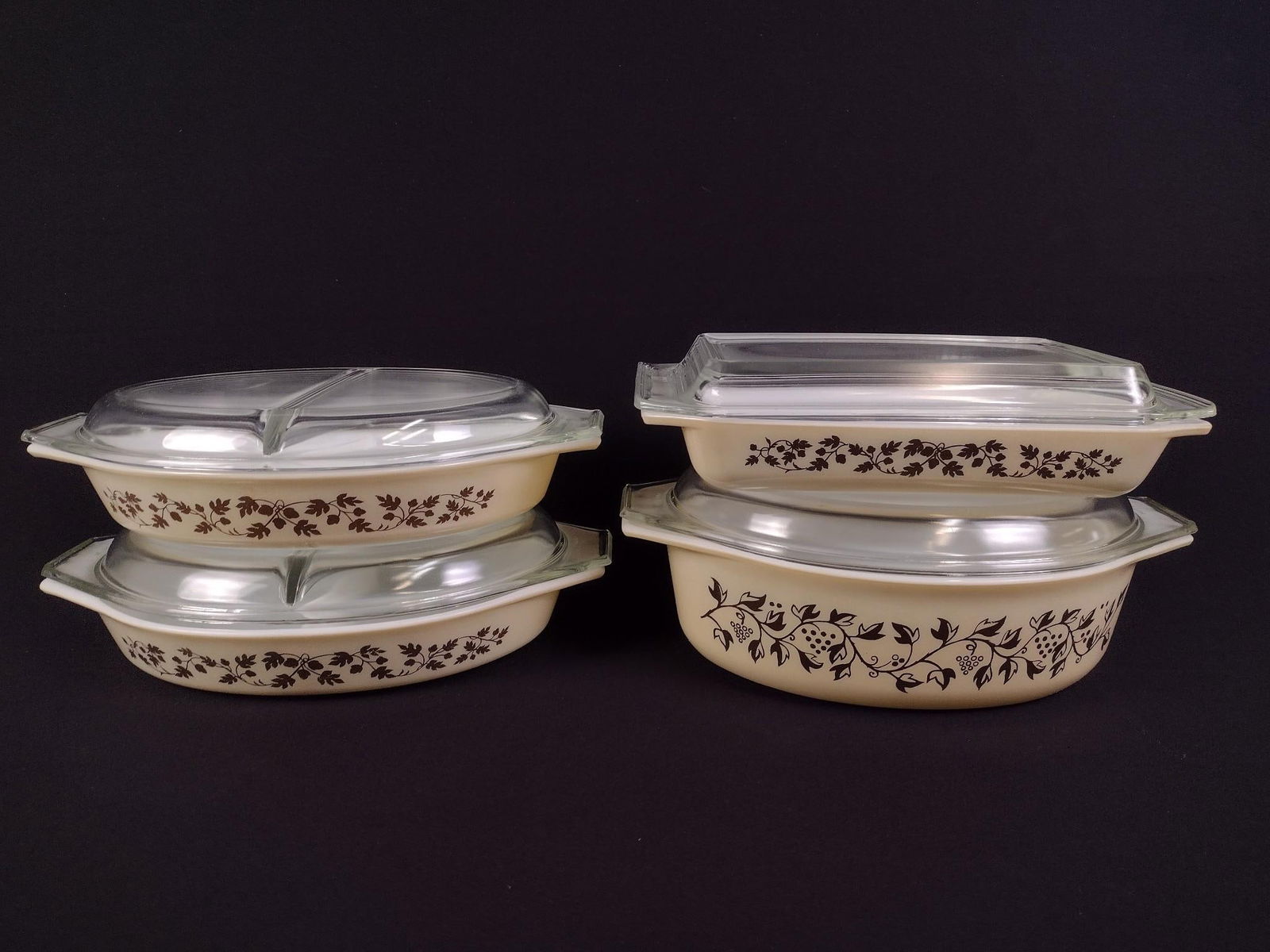 8 Pcs Pyrex Bakeware incl "Golden Acorn" and "Golden Grape Vine": Includes 3 Golden Acorn baking dishes with lids and one Golden Grape Vine with lid. 2" to 3-1/4" high (does not include lid). Some scratches.