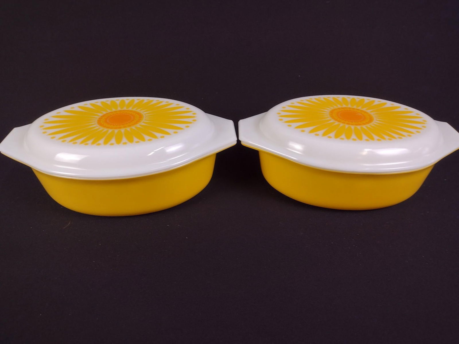 4 Pc Pyrex "Sunflower" Baking Dishes with Lids: Each with lid: 13" wide x 9" deep x 4-3/4" high. Some minor scratches.