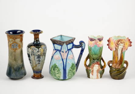 5 Pcs Majolica incl Royal Doulton: 8-1/2" to 9-3/4" high. One Royal Doulton bottle vase with heavy repairs. Pitcher is a modern reproduction. One figural vase with losses to edges. One figural vase with repairs.
