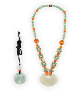 2 Jade Necklaces: DESCRIPTION: Beaded necklace with jade pendant. Pendant engraved with flowers and bird sitting on tree branch. Clasp marked silver. String necklace with carved jade pendant. Pendant with cut outs. MEA