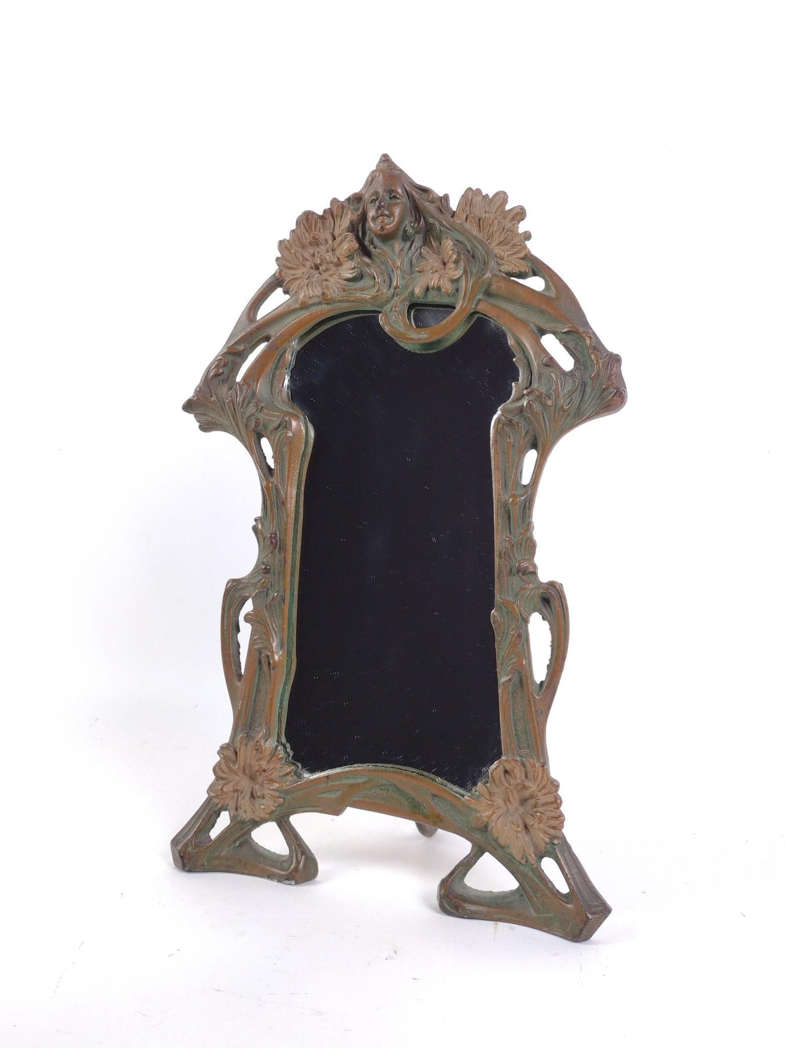 Art Nouveau Cast Iron Standing Mirror with Figural and Floral Accents: 9-1/4" wide X 4-1/2" deep X 15-1/4" high.