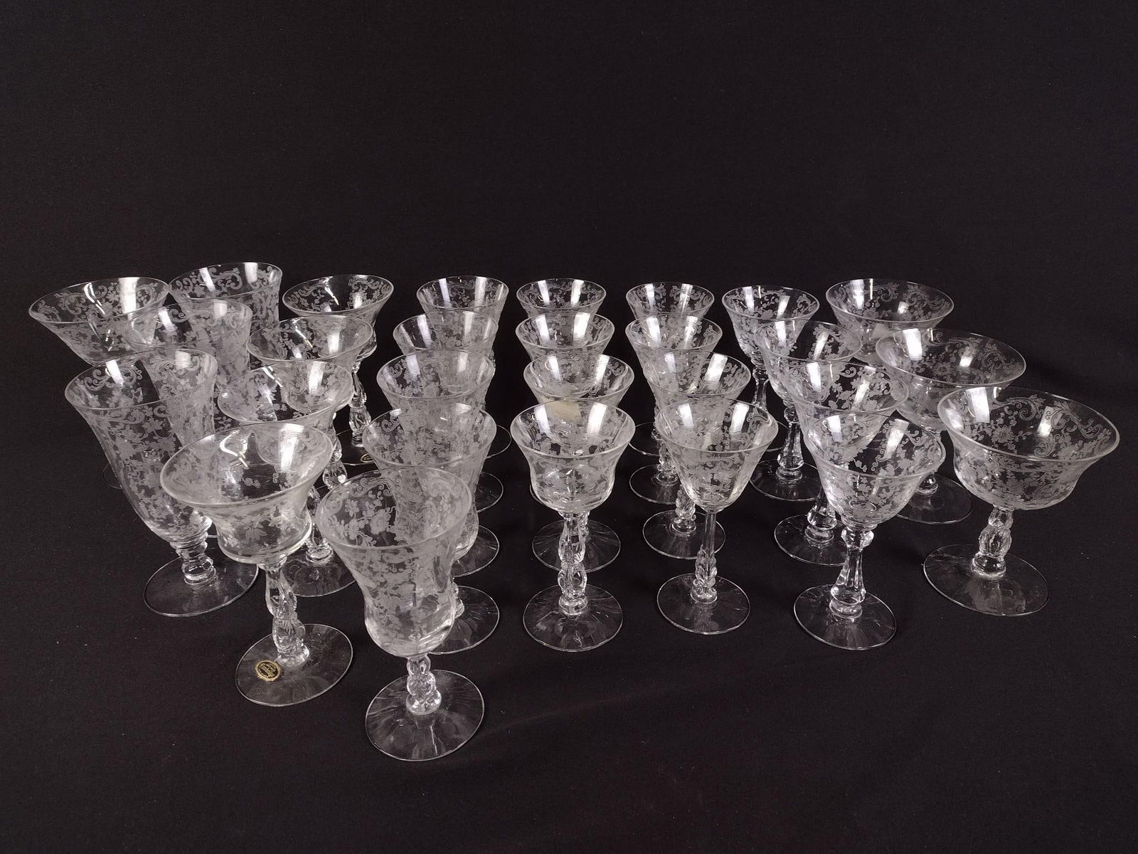 57 Pcs Cambridge "Chantilly" Glassware: DESCRIPTION: Includes, one decanter, seven water/wine goblets with a taller stem, six water/wine goblets with straighter sides, five water/wine goblets with a short stem, eight ice tea glasses, two wi