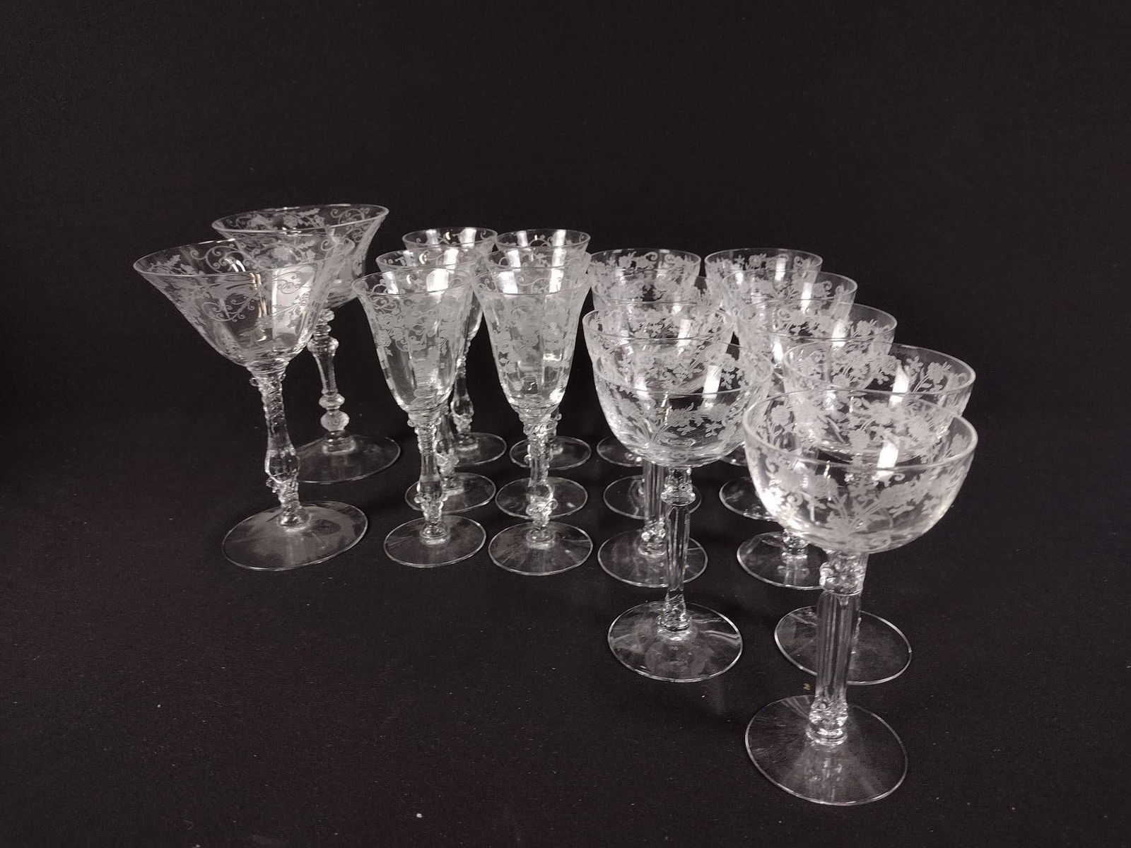 34 Pcs Etched and Cut Glassware: DESCRIPTION: Includes nine Fostoria "buttercup" cocktail glasses, six Cambridge "Elaine" claret wine glasses, two "Elaine" goblets, five Seneca grape champagne glasses, three Kinsley cordial glasses,