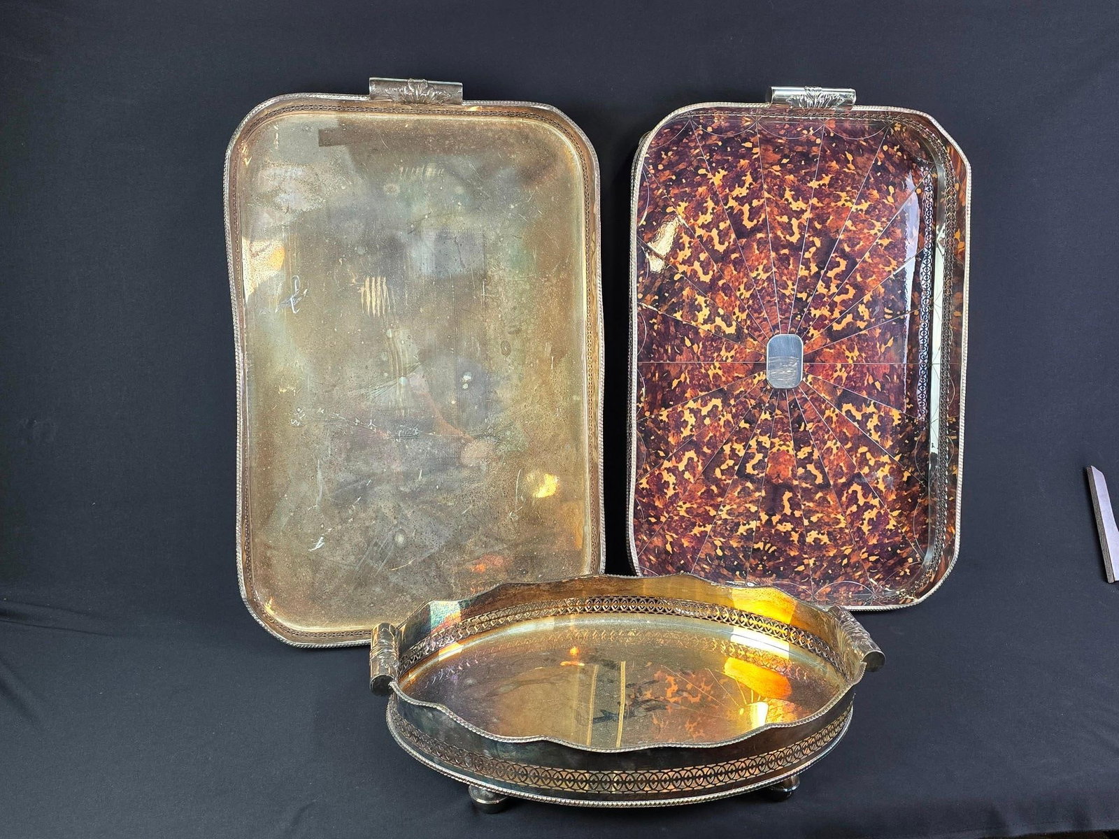 3 English Style SP Trays w/ Gallery incl Faux Tortistshell: NOT ELIGIBLE FOR IN-HOUSE SHIPPING. 2 larger trays: 32-1/4" wide x 20-1/2" deep x 6" high. Smaller tray: 25" wide x 16" deep x 5-1/2" high. All with discoloration and some minor oxidation.