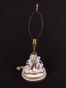 Porcelain Figural Lamp: 9-1/2" wide X 9-1/2" deep X 26-1/2" high. One Cherub has missing head.