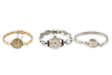 Three Antique Woman's Wrist Watches Including 14K Gold Omega: One a 14k white gold omega with leaf form lugs each enhanced by a round diamond. Clean original dial and original crown. The case shows scratches and contact marks but no substantial wear. The case we