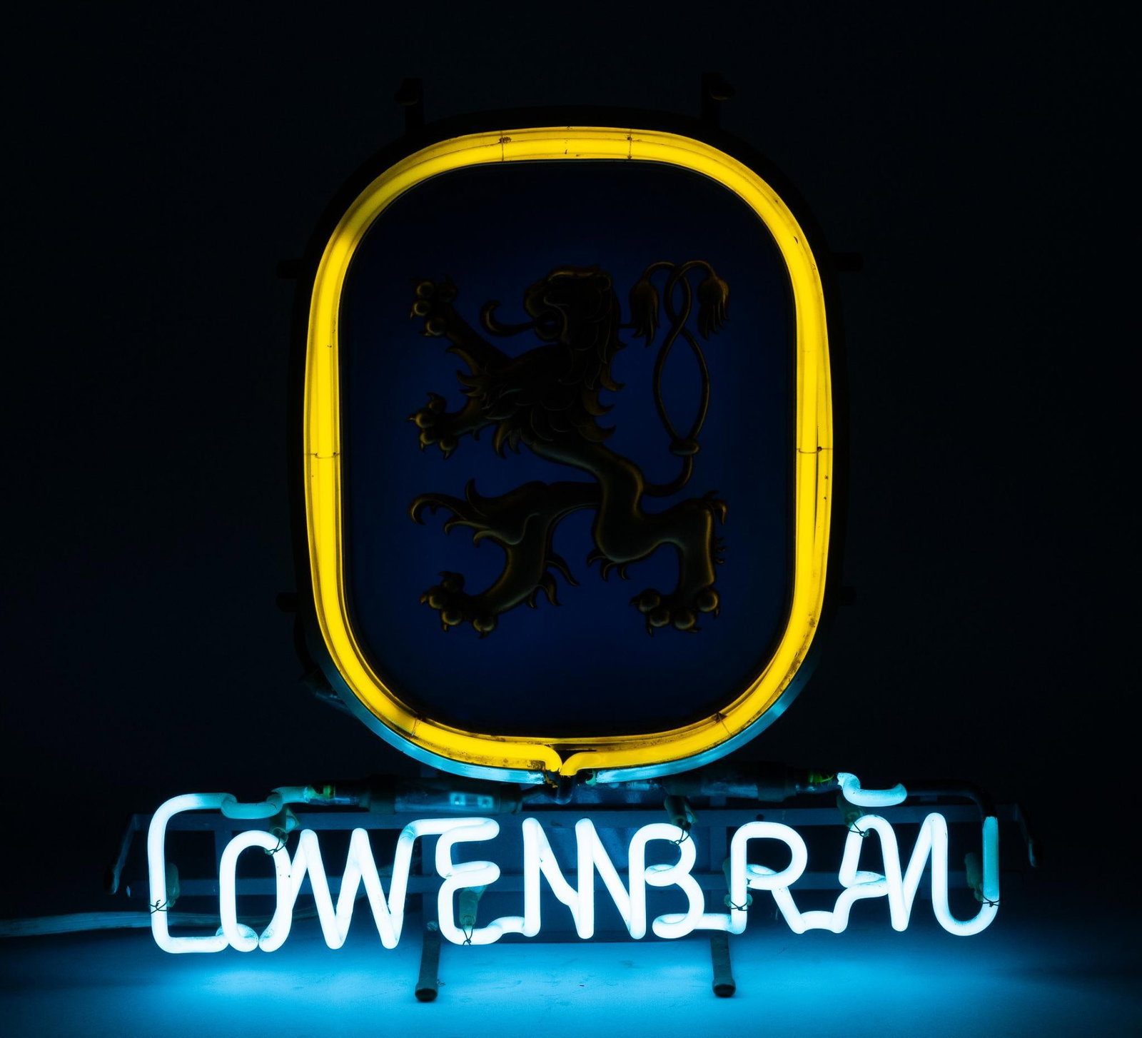 Lowenbrau Neon Sign: NOT ELIGIBLE FOR IN-HOUSE SHIPPING. Working. 18-3/4" wide x 6-1/2" deep x 19" high. PROVENANCE: From the Collection of Robert L. Hassenplug—a proud veteran and small business owner was an avid and p
