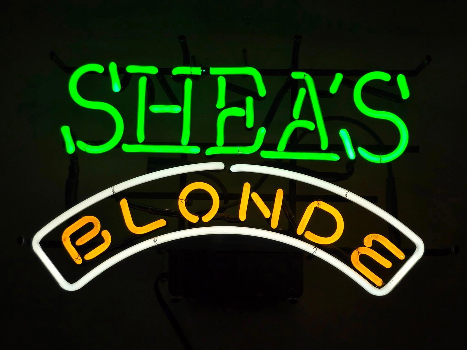 Shea's Blonde Neon Sign: NOT ELIGIBLE FOR IN-HOUSE SHIPPING. Working. Overall: 22-1/4" wide x 6-1/2" deep x 13-3/4" high. Some minor losses to yellow overpaint. PROVENANCE: From the Collection of Robert L. Hassenplug—a prou