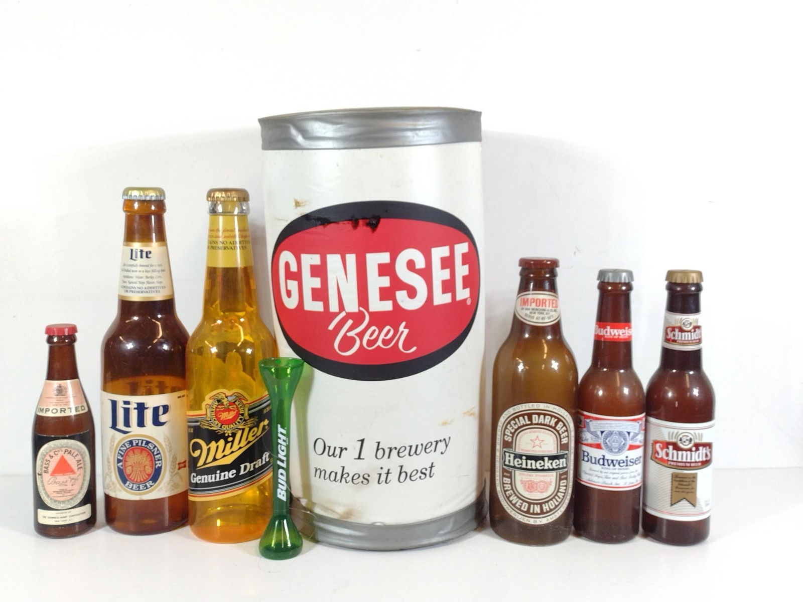 8 Oversized Beer Bottles and Cans: NOT ELIGIBLE FOR IN-HOUSE SHIPPING. Includes light up, plastic, and inflatable. 16-1/2" to 36" high. Some wear consistent with age and use. Lights untested. PROVENANCE: From the Collection of Robert L