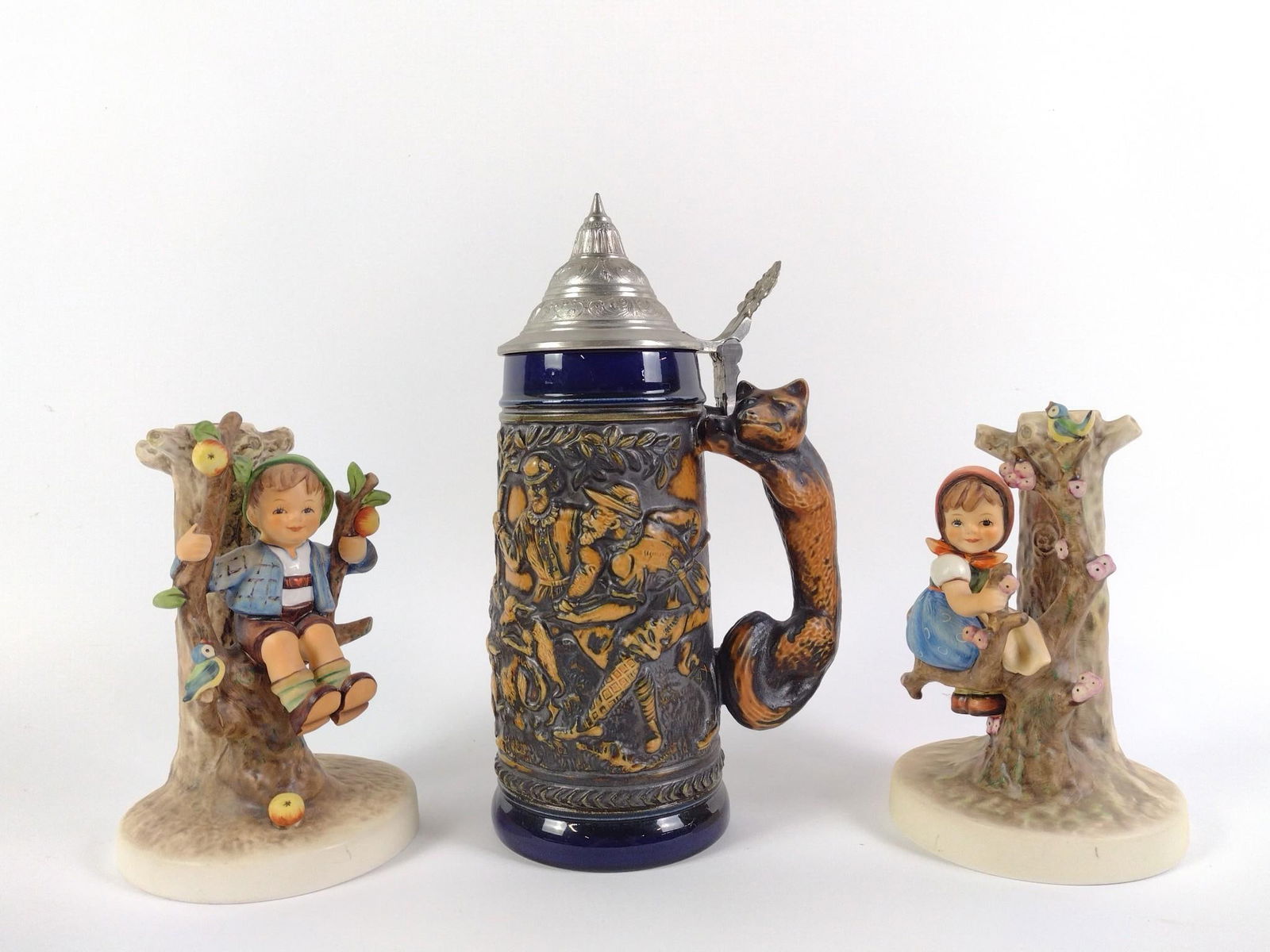 Pair of Hummel Candle Sticks & Beer Stein: 4" to 5-1/2" wide X 6-1/2" to 9-3/4" high.