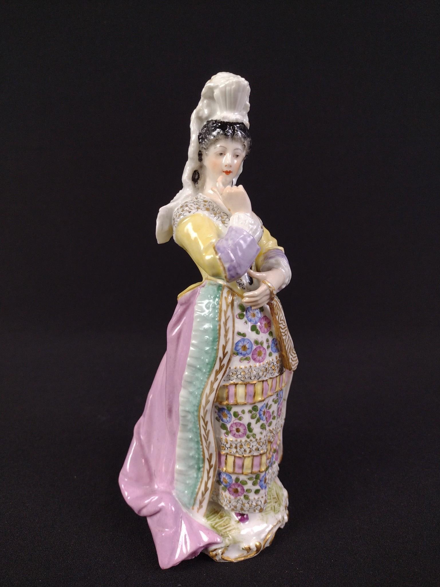 Meissen Figurine of a Woman: 3" wide X 3" deep X 7-1/2" high.