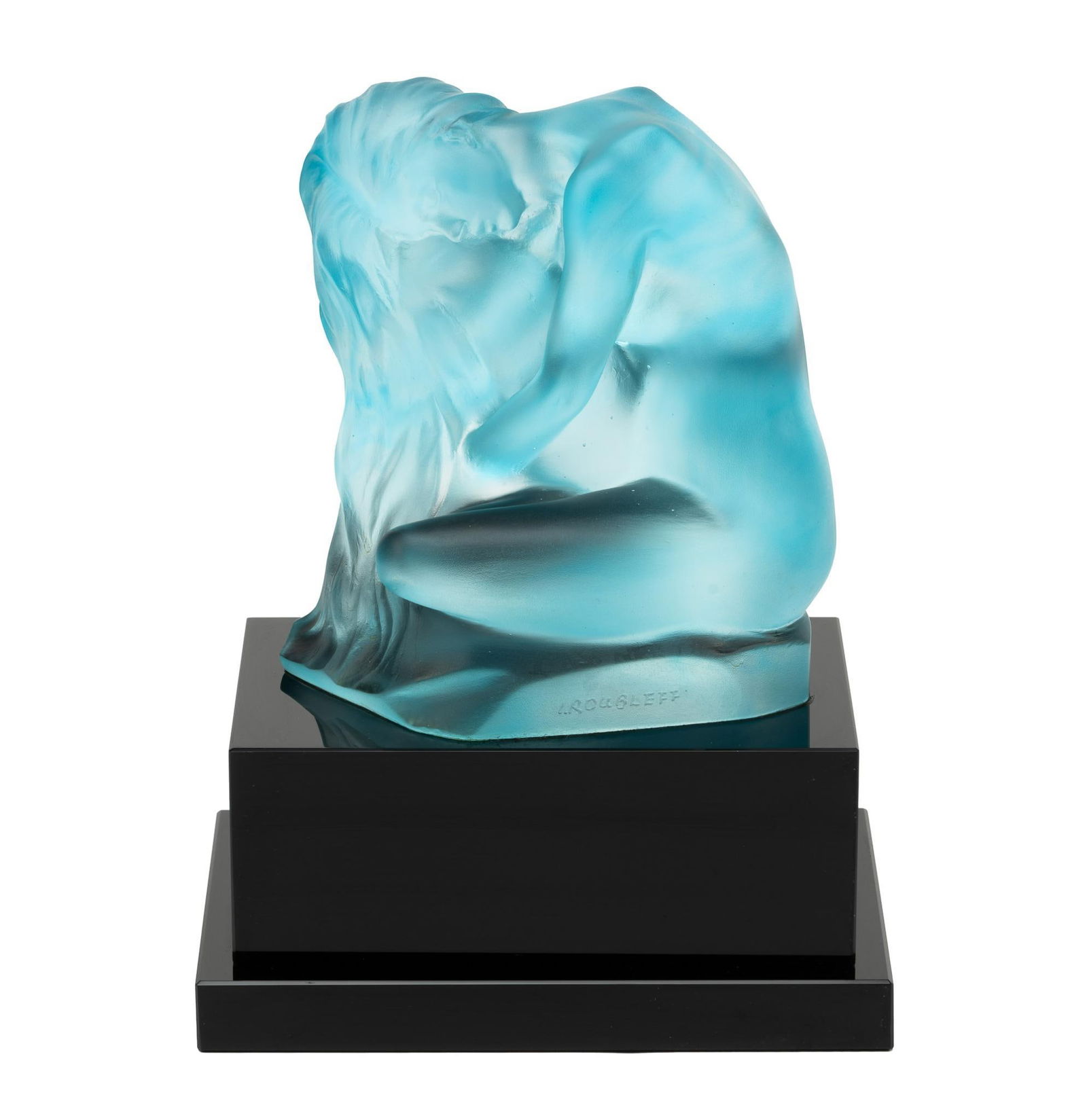 Frosted Blue Glass Sculpture By Roubleff: NOT ELIGIBLE FOR IN-HOUSE SHIPPING. DESCRIPTION: Nude glass female figure on polished black marble base. The piece is inscribed I. Roubleff. MEASUREMENT: Height of 9 1/2" including the base. CONDITION