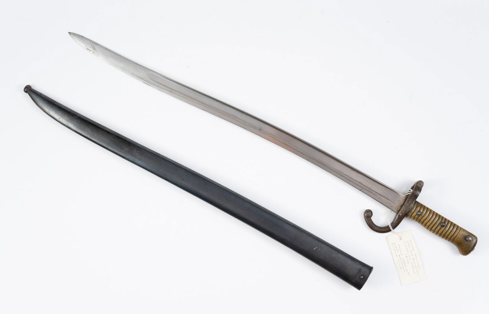 Belgian WWI Comblain Rifle Sword Bayonet: Sword bayonet for Comblain rifle from World War I. Matching numbers on both sheath and bayonet. 28" long. Normal wear and tear associated with age.