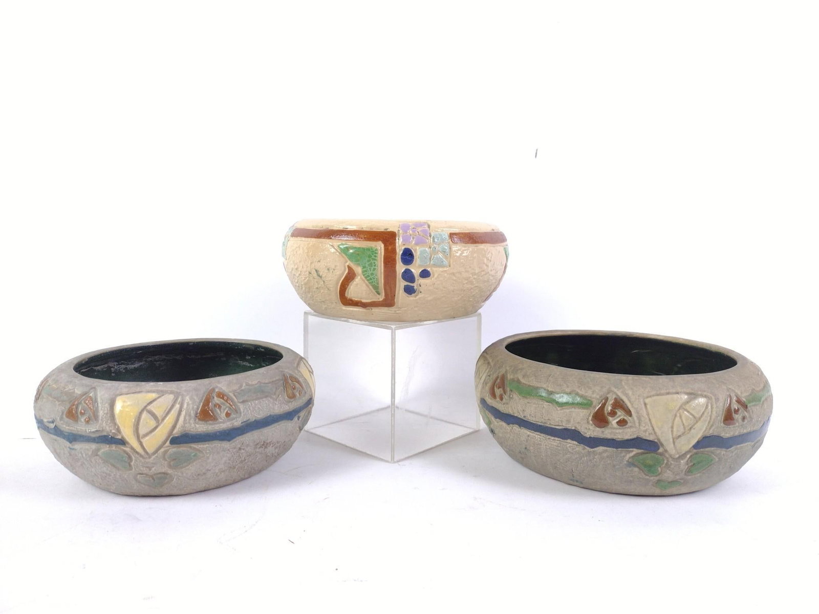 3 Roseville Mostique Art Pottery Bowls: Roseville introduced "Mostique" in 1916 as an early pattern of Arts & Crafts design. Two unmarked. One with impression of RV mark. 6-1/2" to 8" diameter overall. Overall good with normal wear and tear