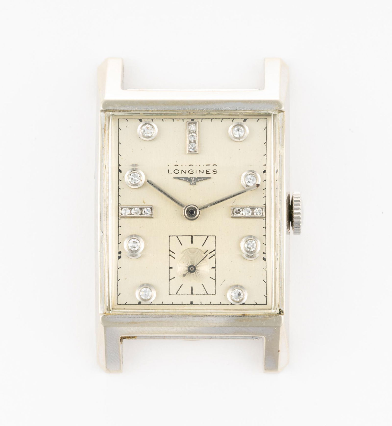 Antique Longines 14K White Gold Rectangular Watch: A 14k white gold Longines manufactured in 1954 with Champion stainless bracelet. The watch has a factory original diamond dial with no flaws and the watch is in near-new condition. It has the original