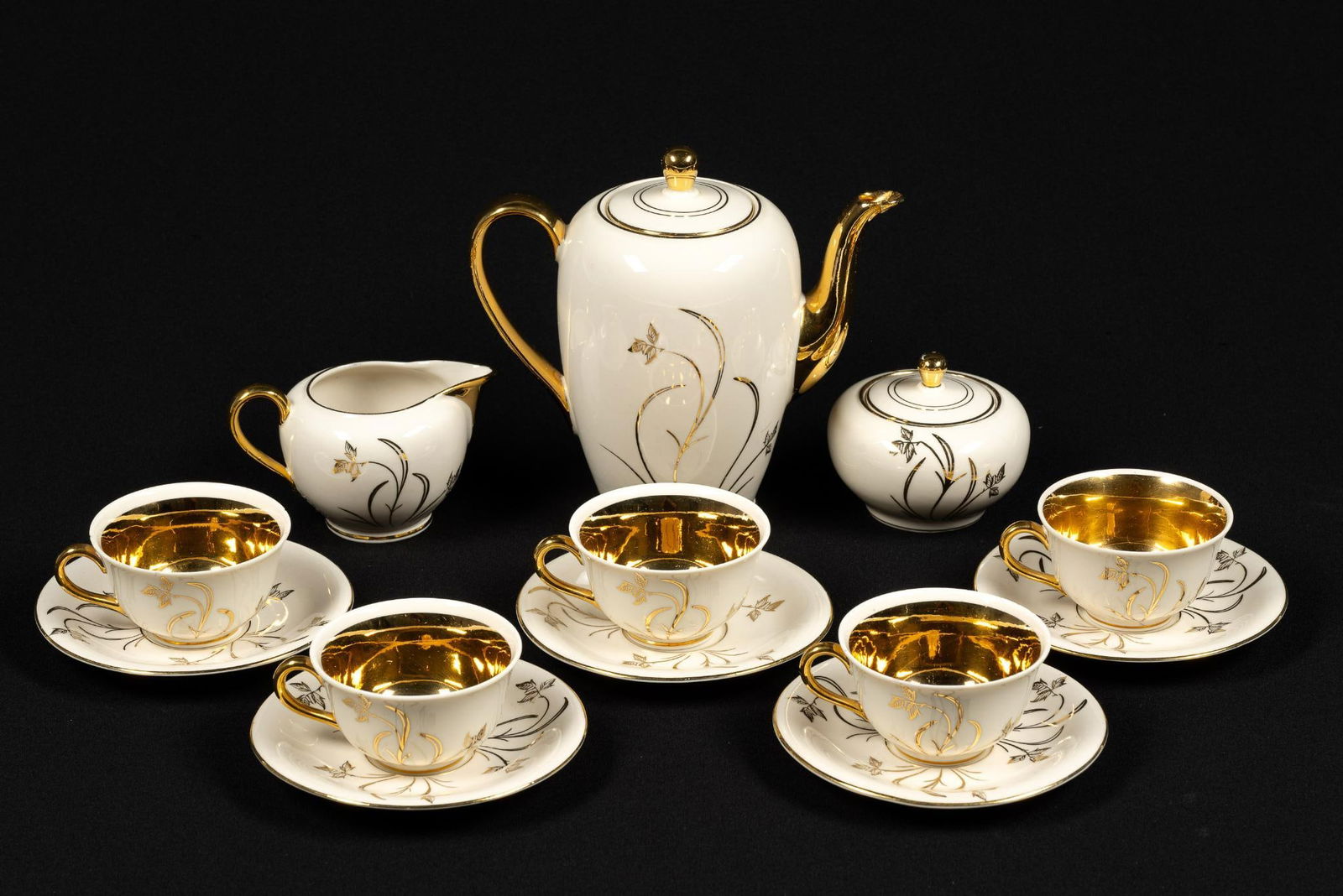 Kerafina Tea Set for 5: Kerafina tea set, 5 cups and saucers. Some chips and repair work. Teapot is 6-1/2" tall, saucers are 5" in diameter.