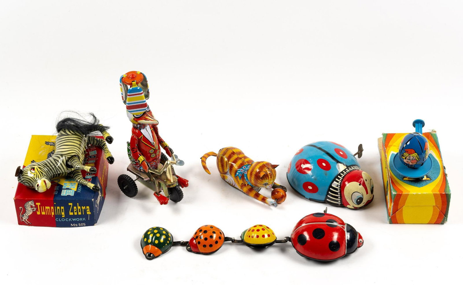 6 Vintage Wind-Up Toys incl USSR Made Toy: Includes toy made in USSR in original box, Turn Over Cat, Jumping Zebra in original box, 2 ladybug toys, and Schylling Duck on Bike. From 2" to 8-1/2" tall and 3-1/2" to 12" long.