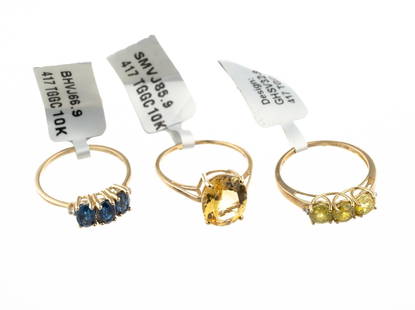 Three 10K Gold Gemstone Rings: All three rings are yellow gold size 9 and have various gemstones including sapphire. The total weight of the rings is 7.1 grams.